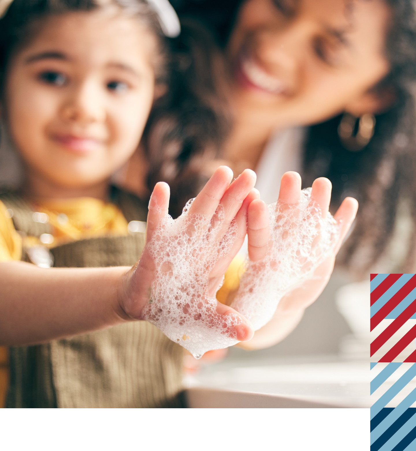 A family together with a daughter showing her soapy hands.